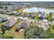 Aerial view of home and neighborhood with lake at 9397 Se 124Th Pl, Summerfield, FL 34491