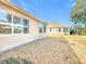 Landscaped backyard with gravel and partial home view at 9397 Se 124Th Pl, Summerfield, FL 34491