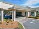 Clubhouse entrance with columns and golf carts at 9397 Se 124Th Pl, Summerfield, FL 34491