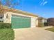 Attached garage with green door and screen door at 9397 Se 124Th Pl, Summerfield, FL 34491