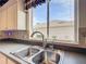 Modern kitchen sink with a window overlooking the backyard at 9397 Se 124Th Pl, Summerfield, FL 34491