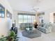 Spacious living room featuring a TV, two sofas, and a ceiling fan at 9397 Se 124Th Pl, Summerfield, FL 34491