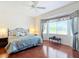 King-size bed, hardwood floors, and bay window in the main bedroom at 9397 Se 124Th Pl, Summerfield, FL 34491