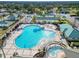 Aerial view of resort-style pool and spa with surrounding lounge areas at 9397 Se 124Th Pl, Summerfield, FL 34491