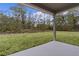 Covered patio overlooking a large backyard at 1 Malauka Pass Ct, Ocklawaha, FL 32179