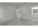 Bright bedroom with wood-look floors and access to bathroom at 1 Malauka Pass Ct, Ocklawaha, FL 32179