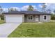 New construction home with gray siding, white garage door, and neat lawn at 1 Malauka Pass Ct, Ocklawaha, FL 32179