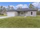 Modern house exterior with gray siding and white garage door at 1 Malauka Pass Ct, Ocklawaha, FL 32179