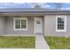 Modern front door with white trim and a walkway leading to the entrance at 1 Malauka Pass Ct, Ocklawaha, FL 32179