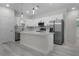 Modern kitchen with white cabinets, stainless steel appliances, and an island at 1 Malauka Pass Ct, Ocklawaha, FL 32179