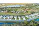 An aerial view of a picturesque community near a tranquil lake, featuring well-kept homes and green landscapes at 10161 Spring Lake Dr, Clermont, FL 34711