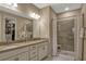 Bathroom featuring double sinks, walk-in shower, and large mirror at 10161 Spring Lake Dr, Clermont, FL 34711