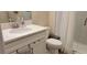 Bathroom with white vanity, quartz countertop, and a walk-in shower at 10161 Spring Lake Dr, Clermont, FL 34711