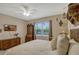 Bedroom featuring a queen bed, vintage furniture, large window, and neutral decor at 10161 Spring Lake Dr, Clermont, FL 34711