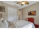 Bright bedroom with a ceiling fan, television, closet and a calming atmosphere at 10161 Spring Lake Dr, Clermont, FL 34711