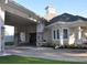 Exterior view of the community clubhouse featuring a covered entrance, stone accents, and well-maintained landscaping at 10161 Spring Lake Dr, Clermont, FL 34711