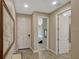 Entry hallway with wood-look tile flooring leading to the bedroom and bathroom at 10161 Spring Lake Dr, Clermont, FL 34711