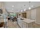 Modern kitchen featuring a large island with pendant lighting open to the dining and living areas at 10161 Spring Lake Dr, Clermont, FL 34711