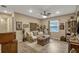 Spacious living room featuring a large sectional sofa, trunk coffee table, and neutral color palette at 10161 Spring Lake Dr, Clermont, FL 34711