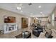 Bright living room featuring a fireplace, ceiling fan, hardwood floors, and modern furniture at 10161 Spring Lake Dr, Clermont, FL 34711