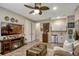 Living room featuring a fireplace, tv, coffered ceiling and wet bar at 10161 Spring Lake Dr, Clermont, FL 34711