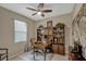 Charming home office with hardwood desk, chair, shelving, and neutral walls at 10161 Spring Lake Dr, Clermont, FL 34711