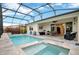 Screened pool and spa with outdoor seating, accessed through sliding glass doors at 10161 Spring Lake Dr, Clermont, FL 34711