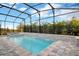 Inviting screened-in pool and spa with a waterfall feature offer a refreshing outdoor space at 10161 Spring Lake Dr, Clermont, FL 34711