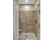 Walk-in shower featuring tiled walls, shower head, and glass door at 10161 Spring Lake Dr, Clermont, FL 34711