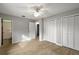 Bedroom with ceiling fan, double door closet and wood-look tile floor at 10830 Anna Belle Ave, Leesburg, FL 34788