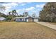 Single story home with blue siding and driveway at 10830 Anna Belle Ave, Leesburg, FL 34788