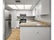 Galley style kitchen with stainless steel refrigerator and granite countertops at 10830 Anna Belle Ave, Leesburg, FL 34788