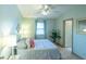 Cozy bedroom featuring a ceiling fan, neutral walls, and a comfortable bed with decorative pillows at 1204 Maria Ct, Lady Lake, FL 32159