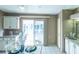 Kitchen nook with white cabinets, tile flooring and sliding glass doors to the lanai at 1204 Maria Ct, Lady Lake, FL 32159