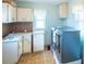 Practical laundry room with modern washer and dryer units, ample storage cabinets, and a utility sink at 1204 Maria Ct, Lady Lake, FL 32159