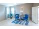 Bright living room with blue accents, hardwood-style floors and natural light at 1204 Maria Ct, Lady Lake, FL 32159