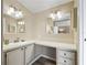 Bathroom with double vanity, large mirror, and updated fixtures at 1210 Tarpon Ln, The Villages, FL 32159