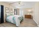 Main bedroom with a queen-size bed, dresser, and ceiling fan at 1210 Tarpon Ln, The Villages, FL 32159