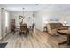 Dining room with hardwood floors, table, chairs, and living room view at 1210 Tarpon Ln, The Villages, FL 32159