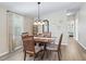 Dining area with a wood table and chairs, hardwood floors and view of living room at 1210 Tarpon Ln, The Villages, FL 32159