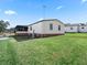 Exterior view of manufactured home with yard at 1210 Tarpon Ln, The Villages, FL 32159