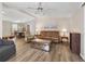 Bright living room featuring hardwood floors, a comfortable couch, and an open floor plan at 1210 Tarpon Ln, The Villages, FL 32159