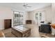 Living room with sliding glass doors to screened porch, hardwood floors and couch at 1210 Tarpon Ln, The Villages, FL 32159