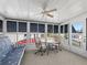 Sunroom with seating area and table, offering a view of the community at 1210 Tarpon Ln, The Villages, FL 32159