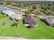 Aerial view of the home showcasing the manicured lawn and mature landscaping at 12886 Se 97Th Terrace Rd, Summerfield, FL 34491