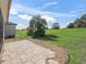 Landscaped backyard with a stone patio and views of the lush green golf course at 12886 Se 97Th Terrace Rd, Summerfield, FL 34491