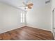 Empty bedroom with wood-look floors, ceiling fan, and window with shutters at 12886 Se 97Th Terrace Rd, Summerfield, FL 34491