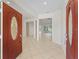 Bright foyer with tile flooring leading into the home's open layout and a gorgeous front door at 12886 Se 97Th Terrace Rd, Summerfield, FL 34491