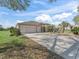 Attractive single-story home featuring a three-car garage and beautifully landscaped front yard at 12886 Se 97Th Terrace Rd, Summerfield, FL 34491