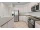 Kitchen with stainless steel appliances, granite countertops and a tiled floor at 12886 Se 97Th Terrace Rd, Summerfield, FL 34491